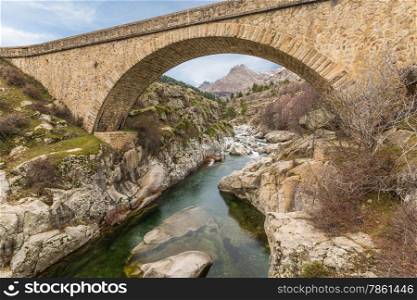 Bridge over the Golo river near Albertacce in central Corsica with Mount Albanu in the distance