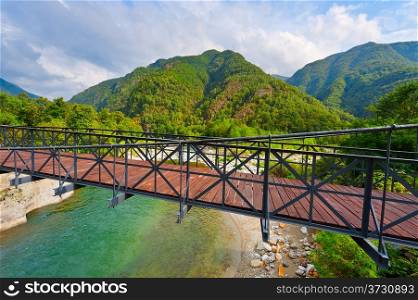 Bridge over the River in the Italian Alps