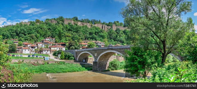 Bridge over the Yantra River near Veliko Tarnovo Fortress, Bulgaria. Hi res panoramic view on a sunny summer day.. Bridge over the Yantra River near Veliko Tarnovo Fortress, Bulgaria