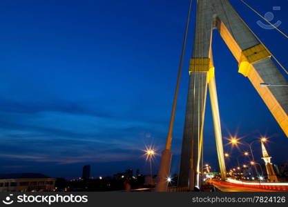 Bridges and roads in the dark the evening sky. The light from the bright lights and the car started up.