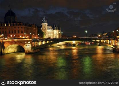 Bridges over Seine and Conciege in nighttime Paris France
