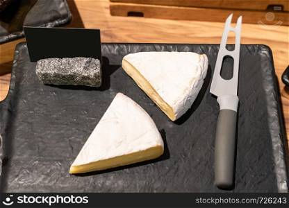 brie cheese on black stone plate in buffet line