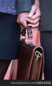 Briefcase in the hand of a Man and Woman