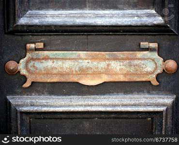 Briefkastenschlitz. antique mail slot in a wooden door