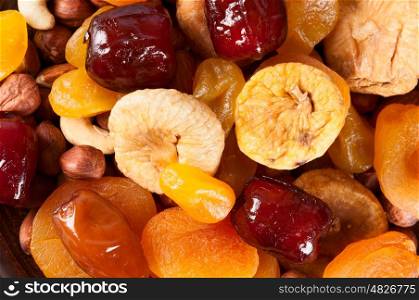 Bright abstract food background. Dried fruits, dates, lemon, apricots, figs and nuts.