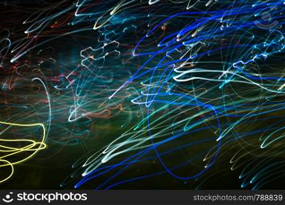 Bright abstract spiral patterns from light strips on a black background. Bright rounded patterns from light strips on a black background