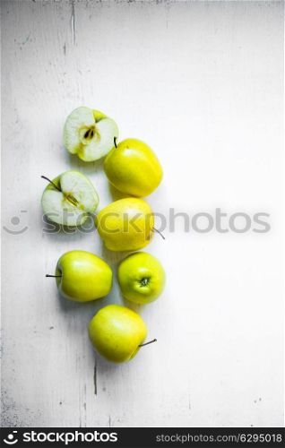 Bright apples on white wooden background