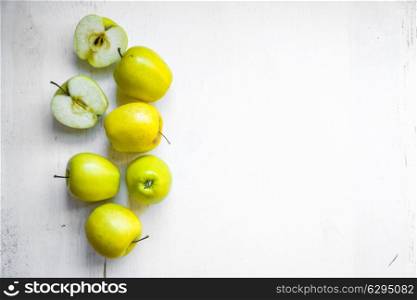 Bright apples on white wooden background