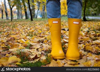 bright autumn. girl in yellow rubber boots walking
