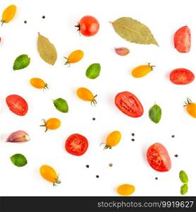 Bright background from cherry tomato, garlic, pepper and bay leaf. Vegetables isolated on white background.