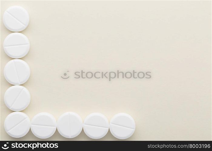 Bright background with white pills. Bright background with the figure is made up of white pills
