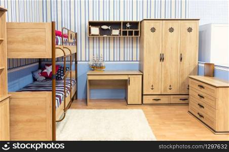 Bright bedroom with a stripped bed with colorful pillows and big cupboard