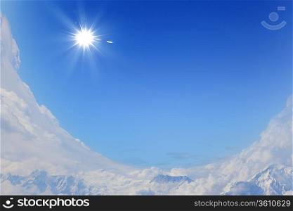 bright blue sky with sun shining and some clouds