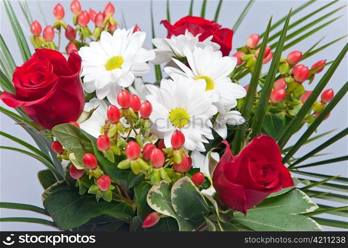 Bright bouquet with chamomiles and roses
