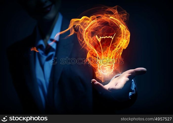 Bright burning idea concept. Idea concept with glowing bulb symbol in palm on dark background