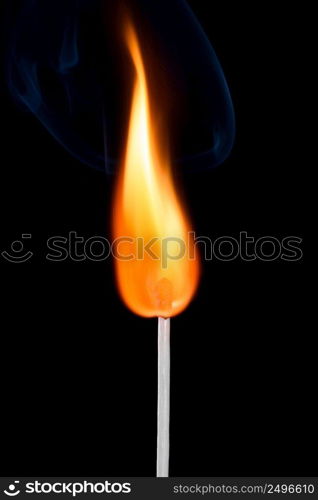 Bright burning match stick with fire and smoke isolated on black background