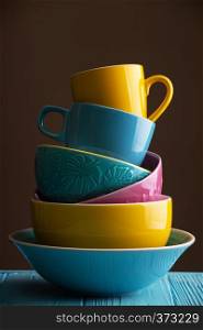 bright ceramics - cups and bowls in blue, yellow and pink colors
