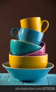 bright ceramics - cups and bowls in blue, yellow and pink colors