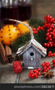 Bright christmas composition with small bird house and mulled wine