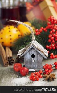 Bright christmas composition with small bird house and mulled wine