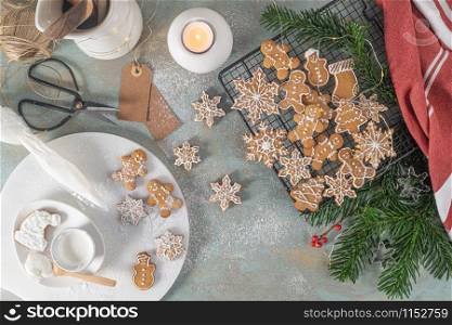 Bright Christmas or New Year wooden background with fir branches, Christmas decorations, Christmas gingerbread cookies, Christmas sweets.