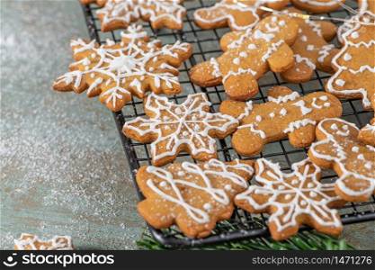Bright Christmas or New Year wooden background with fir branches, Christmas decorations, Christmas gingerbread cookies, Christmas sweets.