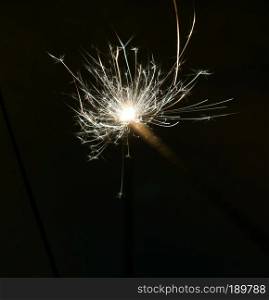 Bright christmas sparkler, bengal fire burning in the night.                       
