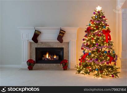 Bright Christmas tree and glowing fireplace in living room.