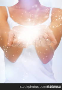 bright closeup picture of magic twinkles on female hands