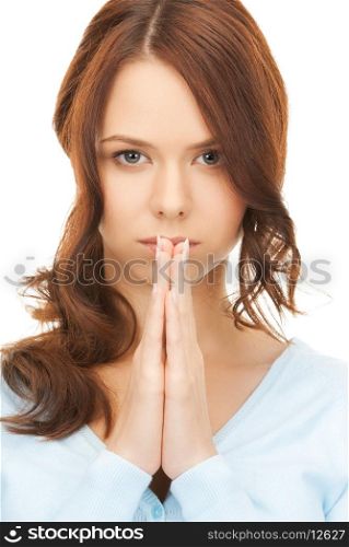 bright closeup picture of young praying woman