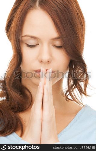bright closeup picture of young praying woman