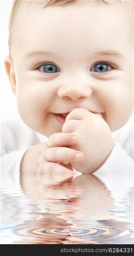 bright closeup portrait of adorable baby in water