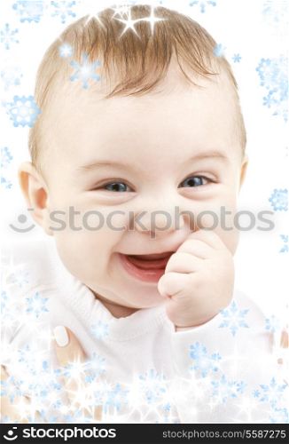bright closeup portrait of adorable baby with snowflakes