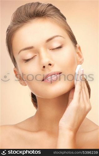 bright closeup portrait picture of beautiful woman with cotton pad