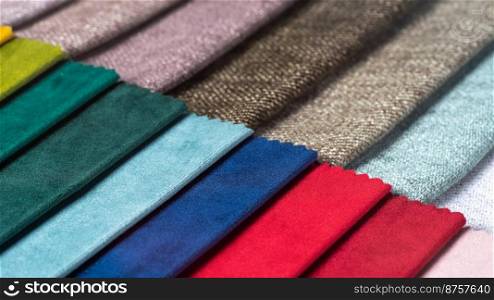 Bright collection of colorful textile samples. Fabric swatches, set in different colors for selection. Variety colors of upholstery material for furniture and interior. Fabric texture background