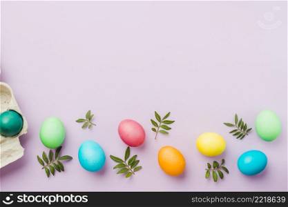 bright collection row colored eggs near container plants