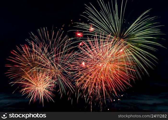 Bright colored fireworks on a black background. Celebration and holidays concept. New Year, Independence Day, July 4 Festival. Bright explosions of lights in the sky. Place for your text.. Bright colored fireworks on black background. Celebration and holidays concept. New Year, Independence Day, July 4 Festival. Bright explosions of lights in the sky.
