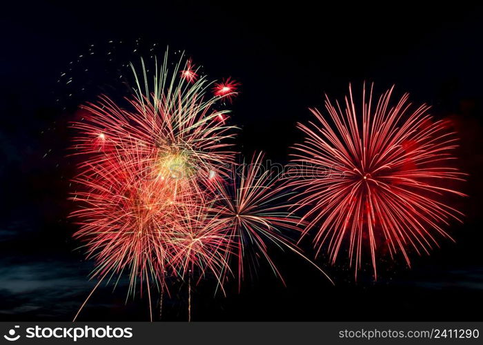 Bright colored fireworks on a black background. Celebration and holidays concept. New Year, Independence Day, July 4 Festival. Bright explosions of lights in the sky. Place for your text.. Bright colored fireworks on black background. Celebration and holidays concept. New Year, Independence Day, July 4 Festival. Bright explosions of lights in the sky.