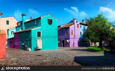 Bright colored houses on the street in Burano, Italy. Bright colored houses