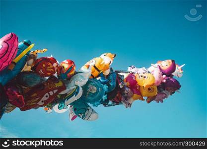 Bright colorful baloons on blue deep sky background
