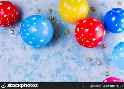 Bright colorful carnival or party scene. Bright colorful carnival or party scene of balloons on blue background. Flat lay style, birthday or party greeting card with copy space.