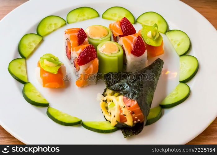 Bright colour Sushi with fruit on a white plate