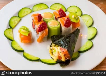 Bright colour Sushi with fruit on a white plate