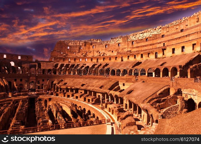 Bright crimson sunset over the ancient Colosseum. Rome. Italy