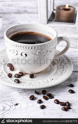 Bright Cup of coffee. Light set with light coffee on wooden background