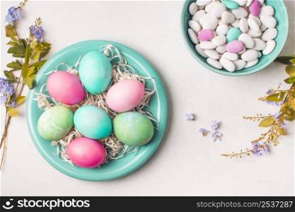 bright eggs plate near little stones bowl flower twigs