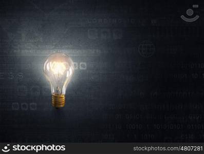 Bright electric bulb. Glowing glass light bulb on digital background