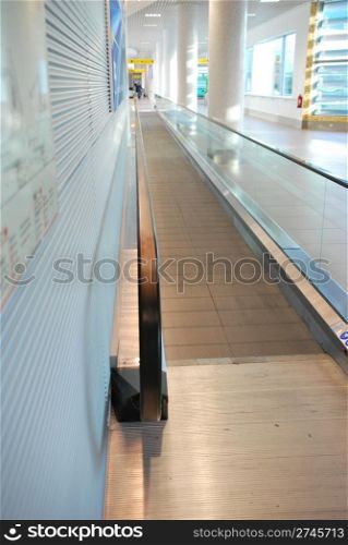 bright entrance on a moving escalator in a international airport