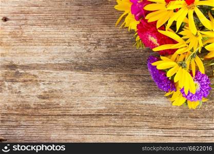 Bright fall bouquet on wooden background with copy space. Bright fall bouquet