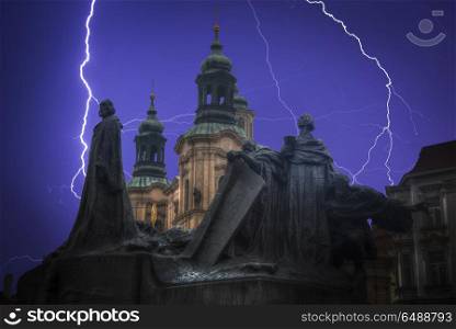 bright flashes of lightning.Monument to Jan Hus is located in the Old Town Square of Prague.. bright flashes of lightning